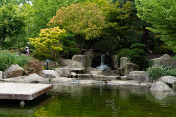 Fototapeta na wymiar Japanischer Garten in Hamburg 2022 Wasserfall - Kaskade im Park.