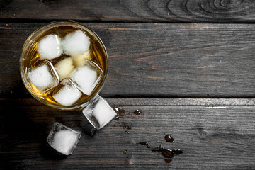 Whiskey in a glass with ice cubes.