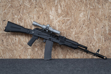 Assault rifle with a telescopic sight, close-up photo.