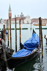 View of San Giorgio Maggiore church with ships transporting people around it and gondola in the foreground. © Eduardo Accorinti