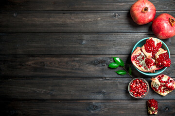 Grains of ripe pomegranate in bowl.