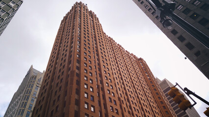 Looking up from the street to the landmark skyscraper Guardian Building in downtown Detroit, Michigan at the intersection of Griswold and Congress Streets. Built in 1928, art deco office building.  - obrazy, fototapety, plakaty