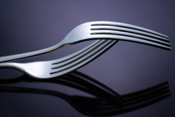 Close up of kitchen forks on dark background with selective focus
