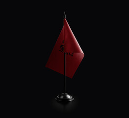 Small national flag of the Albania on a black background