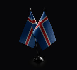 Small national flags of the Iceland on a black background