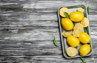 Juicy lemons on a baking sheet.