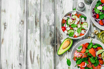 Various salads of organic vegetables, fish and cheese with olive oil and spices .
