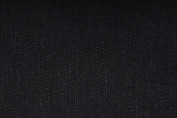 the texture of denim is gray with a side double seam. thread stitches on the background of denim textiles. place to copy. Abstract background and texture for design.