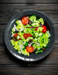 Vegetable salad. Salad of cucumbers, tomatoes and red onions with spices and olive oil.