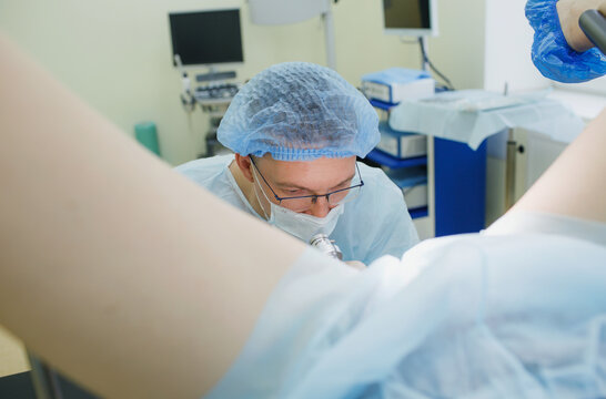 a proctologist examines a rectal colonoscopy patient lying on a medical chair in the surgical office. Rectal examination.