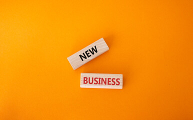 New business symbol. Concept words New business on wooden blocks. Beautiful orange background. Business and New business concept. Copy space.