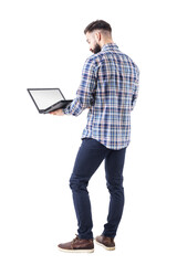 Standing professional business man holding and using laptop computer with blank screen. Full body isolated on transparent background.