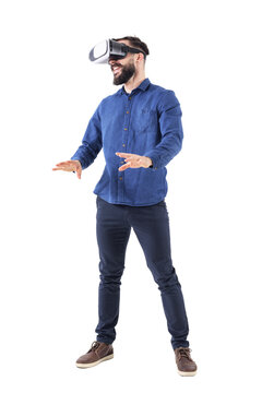 Excited young business man watching vr glasses laughing and gesturing with hands. Full body isolated on transparent background.