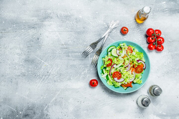 Vegetable salad. Salad of cucumbers, tomatoes and red onions with spices and olive oil.