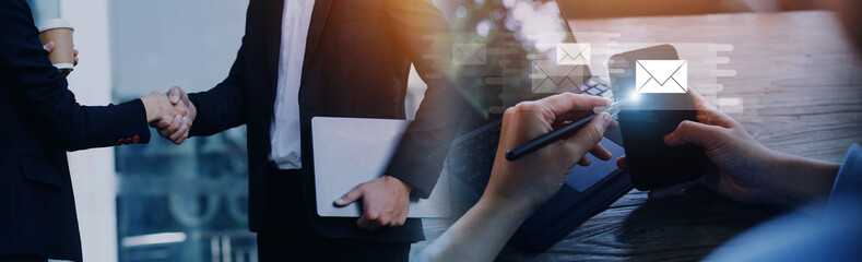 Businessman hands using Laptop typing on keyboard and surfing the internet on office table with...
