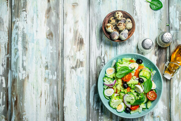 Vegetable salad. Salad of tomatoes, cucumbers and quail eggs with olive oil.