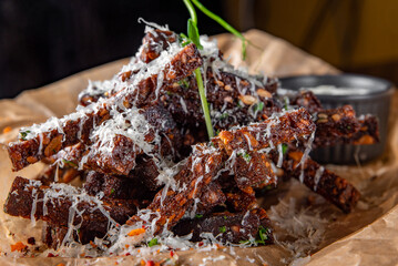 Deep fried rye croutons with grated parmesan cheese and garlic