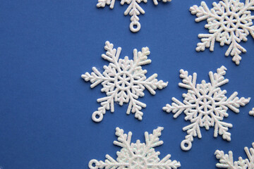 Snowflakes on a blue background. Winter background.