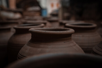 Fototapeta na wymiar Potter manufactured artsy clay pots drying outdoors in large quantities in Dharavi