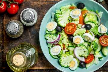 Vegetable salad. Tomato, cucumber and quail egg salad with olive oil and Basil.