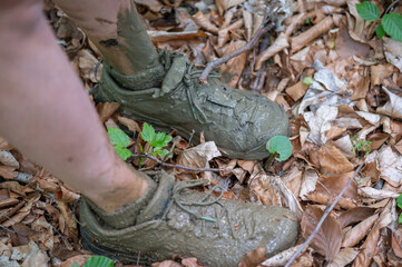 women's shoes and feet from wet dirty mud and dirt after crossing a muddy stream