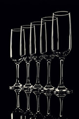 glass goblets outlined with light on a black background