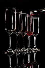 glass goblets outlined with light on a black background