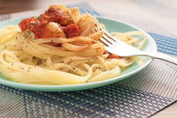noodles on a blue plate with vegetables