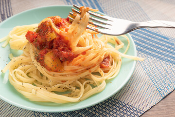 noodles on a blue plate with vegetables