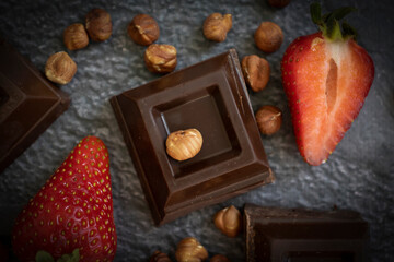 Chocolate piece fresh strawberries on a dark background