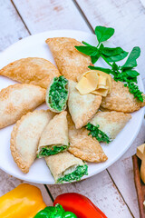 Spinach and cheese empanadas. Ingredients. White wood background. Albacca. Close-up.