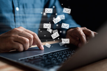 Businessman sending email by laptop computer  to customer, business contact and communication, email icon, email marketing concept, send e-mail or newsletter, online working internet network.