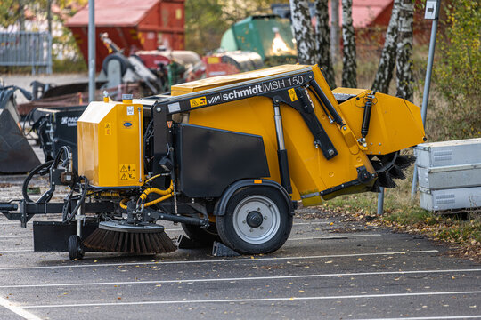 Gothenburg, Sweden - October 16 2022: Towed trailer sweeper at a parking lot.