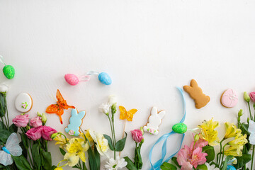 Easter background flowers bunny cookies light surface