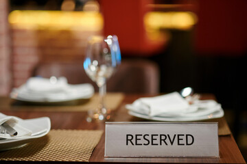 Reserved sign on table in fancy restaurant