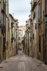 Naklejka premium Montpellier, Occitanie, France - Narrow alley in mediterranean style