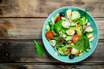 Vegetable salad. Tomato, cucumber and quail egg salad with olive oil and Basil.