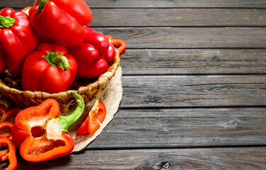 Sweet pepper in a basket and pieces of fresh pepper.