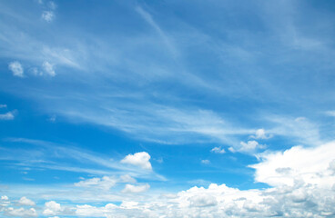 The sky is large, bright, beautiful and has white clouds.