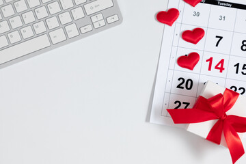 Valentine's Day background. Date February 14 on calendar 2023. office table desk gift box and valentine hearts. Valentines day concept. Flat lay, top view, copy space