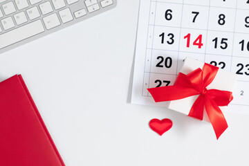 Valentine's Day background. Date February 14 on calendar 2023. office table desk gift box and...