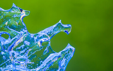 frozen water drops on a green background.blue ice patterns of unusual natural shape.beautiful...