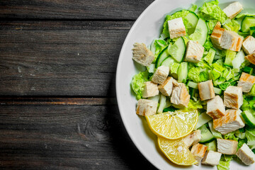 Healthy salad. Salad with cucumbers, chicken and Chinese cabbage poured lemon juice .