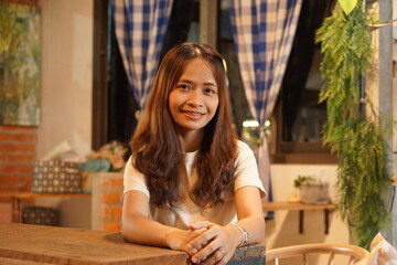 Asian woman smiling happily in a cafe