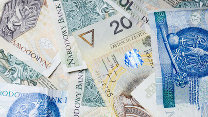 Cash money banknotes background. Photo for banner on website. Photo of accountancy or banking background. 100 zlotys, 200 zlotys, 50 zlotys. Changes in wages and taxes. Rising inflation. PLN