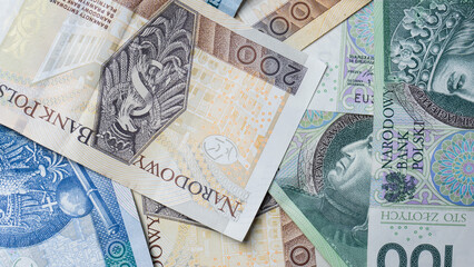 Cash money banknotes background. Photo for banner on website. Photo of accountancy or banking background. 100 zlotys, 200 zlotys, 50 zlotys. Changes in wages and taxes. Rising inflation. PLN