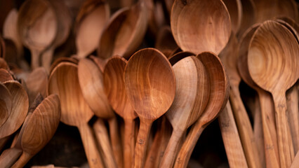Spoons of different sizes made of wood, handmade kitchen utensils.