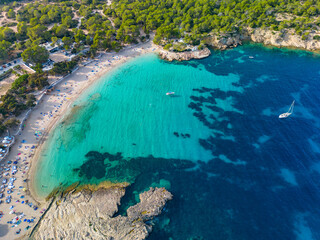 Ibiza Cala Bassa beach with turquoise water, aerial views