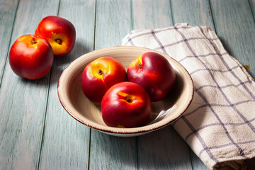 Fresh red nectarines. Wooden background.