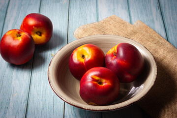 Fresh red nectarines. Wooden background.